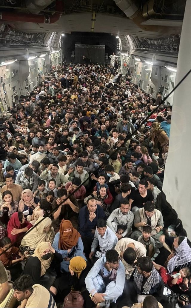 Image provided by US Air Mobility Command shows hundreds of Afghans fleeing Kabul aboard a US C-17 cargo plane, August 15, 2021.