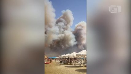 Video: Smoke from wildfires forces swimmers out of Italy