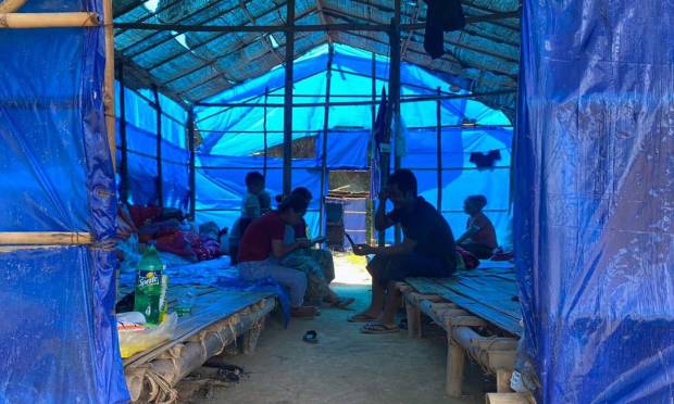 Myanmar refugees rest in a shelter at Farkaon quarantine camp in the eastern Indian state of Mizoram Photo: STR / AFP