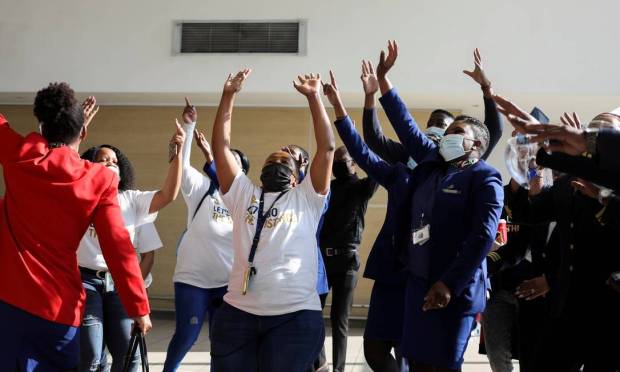 Workers celebrate as a South African Airways (SAA) plane prepares to take off at Tambo International Airport in Johannesburg, South Africa, after a year-long layover because the national airline ran out of money.  Photo: SIPHIWE SIBEKO / REUTERS
