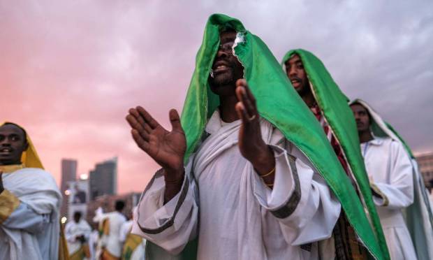 Singers of an Orthodox church sing on the eve of the Mestalian Ethiopian Orthodox holiday commemorating the discovery of the true cross of Christ by the Roman Empress Helena in the 4th century in Addis Ababa, Ethiopia.  SOTERAS / AFP