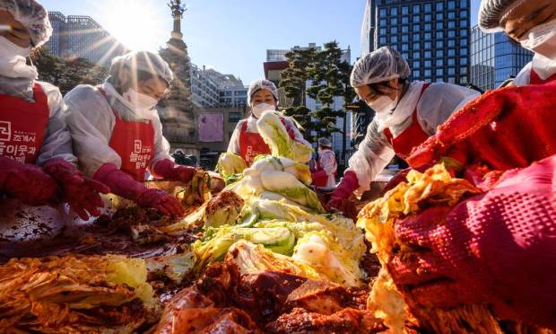 Participants prepare Korean traditional food, fermented and spicy cabbage and radish, during a festival at the Jogieza Buddhist Temple in Seoul.  Photo: ANTHONY WALLACE / AFP