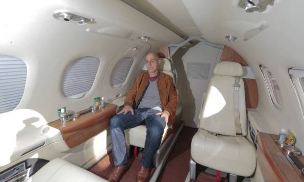 Businessman Marcelo Bellodi settles on his Embraer Phenon 100, which is available for charter flights in the Tropic Air hangar when he's not using it. Photo: Edilson Dantas/Agência O Globo/2-7-2021