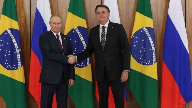 Putin and Bolsonaro greet each other during a meeting in 2019