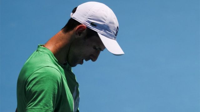 Novak Djokovic looks down on court