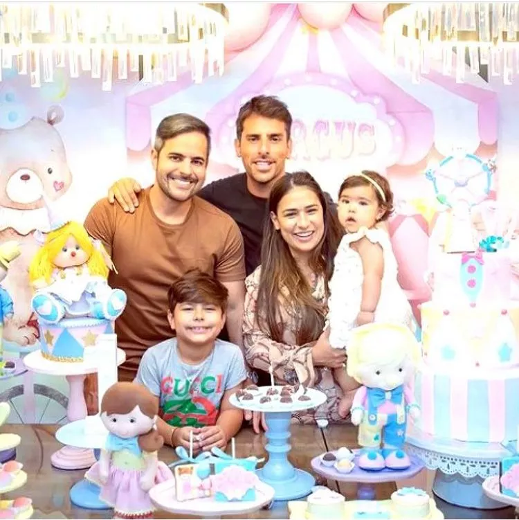 Simon poses with his family at a baby shower in the United States