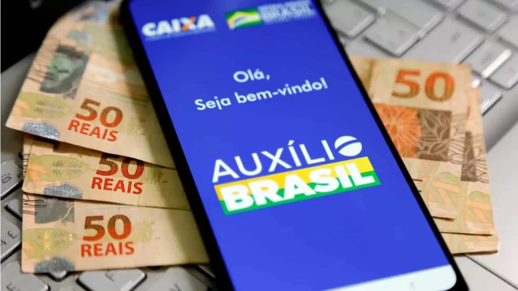 How is the Auxílio Brasil shipment fee paid?