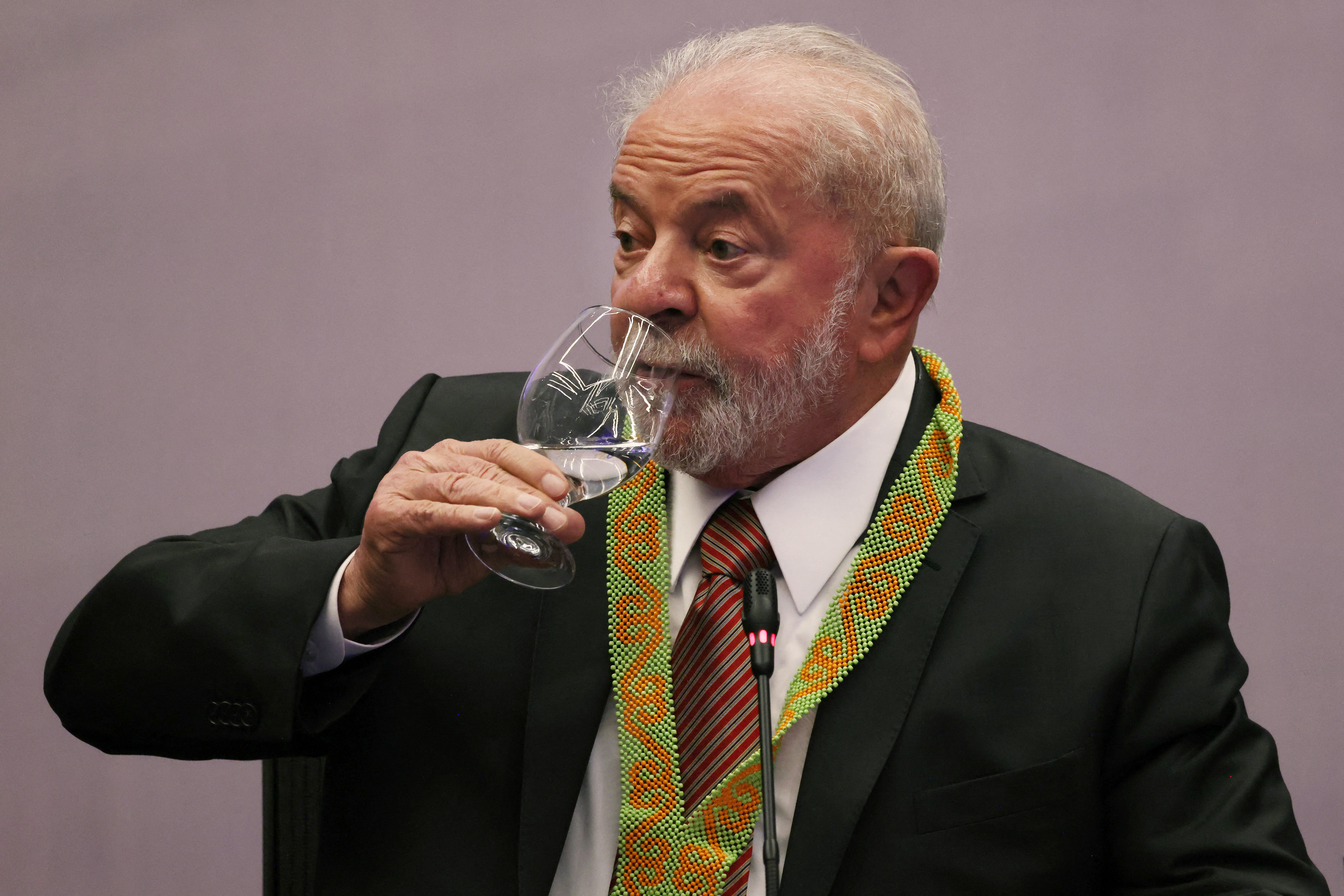 Brazilian President-elect Luiz Inacio Lula da Silva drinks wine during an event with representatives of Brazil's indigenous peoples at the COP27 climate conference in the Red Sea resort city of Sharm el-Sheikh, Egypt, on November 17, 2022.  (Photo by Ahmed Garabli/AFP)